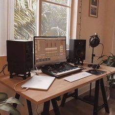 there is a computer on the desk with speakers next to it and a keyboard in front