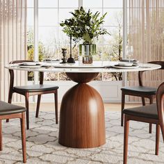 a dining room table with chairs and a vase filled with greenery on the top