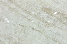 a white marble counter top with light brown veining