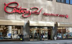 the entrance to a department store with people walking by