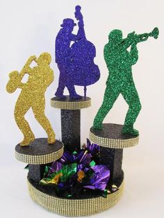 three tinker figurines are standing on top of each other in the shape of people