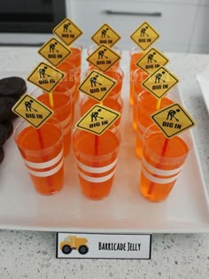 there are many orange cups with signs on them