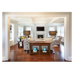 a living room filled with furniture and a fire place in the middle of a room