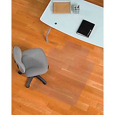 an overhead view of a desk with a chair and laptop on it, next to a coffee table