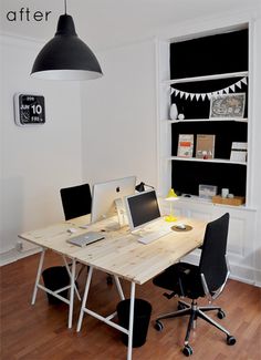 a table with two laptops on it in front of a book shelf and bookshelf