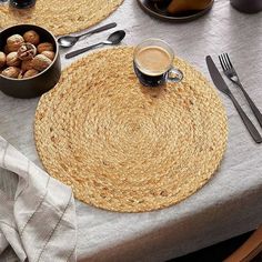 two placemats on a table with utensils and silverware next to them