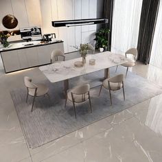 a dining room table and chairs in front of a kitchen with an island countertop