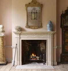 a living room with a fire place in the center and a mirror on the wall