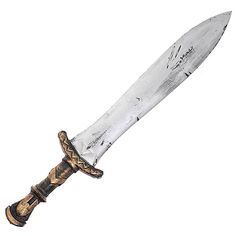 a large knife that is sitting on top of a white surface with gold trimmings