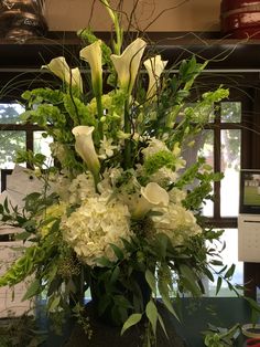 a vase filled with white flowers on top of a table