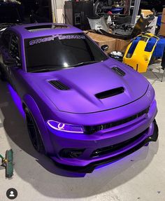 a purple sports car parked in a garage