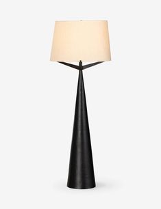 a black lamp with a white shade on it