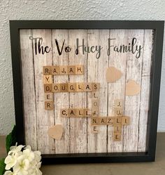 a wooden scrabble frame with the words'the voy hey family '