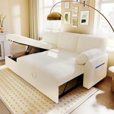 a white couch with a pull out bed underneath it