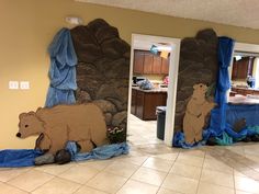 two murals depicting bears in the kitchen and on the floor with blue tarp covering them