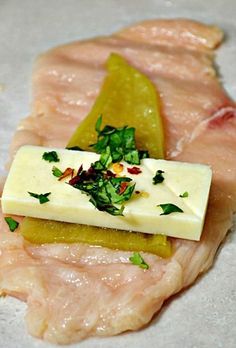 raw fish fillets with cheese and herbs on them