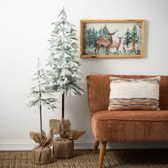 a small christmas tree sitting next to a couch