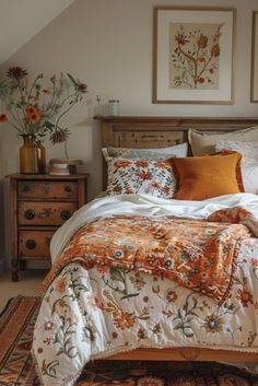 a bed with an orange and white comforter on top of it next to a dresser