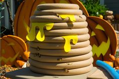 a stack of fire hoses sitting on top of a table next to pumpkins