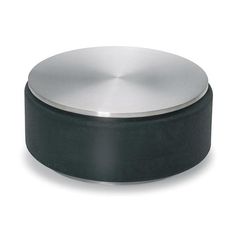 a black and silver object is on a white surface with a circular base in the middle