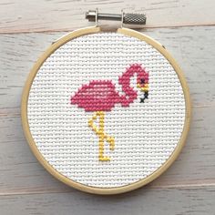 a flamingo cross stitched onto a hoop