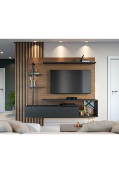 a living room with a large tv on top of a wooden wall mounted entertainment center