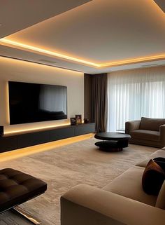 a living room with couches and a flat screen tv mounted on the wall above it