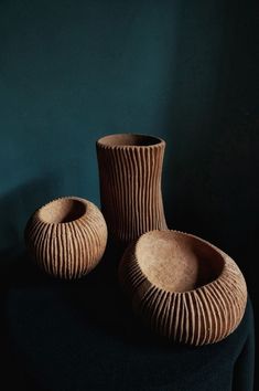 two brown vases sitting on top of a black table