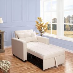 a living room scene with focus on the couch and footstool in the foreground