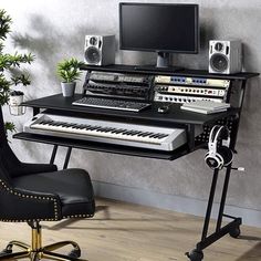 a computer desk with a keyboard, monitor and headphones sitting on top of it