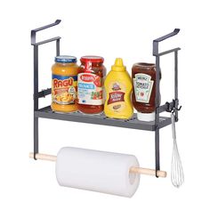 a metal shelf with various condiments on it and a roll of paper next to it