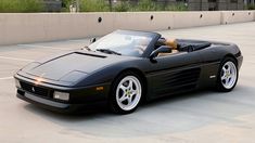 a black sports car parked in a parking lot