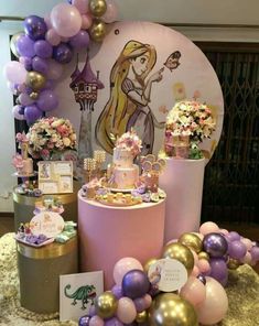 a table topped with lots of cakes and balloons