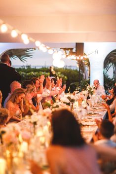 a group of people sitting around a dinner table