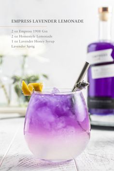 a purple drink with lemon wedges in it