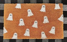 a door mat with ghost faces on it