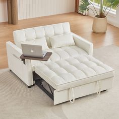 a white couch with a laptop on top of it