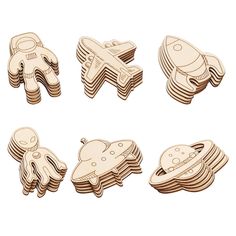 wooden cutouts of different shapes and sizes with an airplane, spaceship, and rocket ship