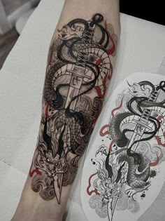 a person with a tattoo on their arm next to a white and black dragon design