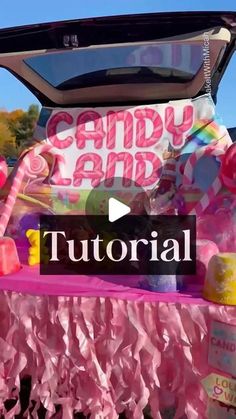 the trunk of a candy land car is decorated with pink tissue paper and candies