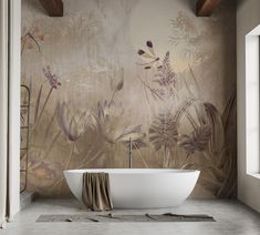 a bath tub sitting in front of a wall with flowers and plants painted on it