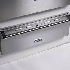 a stainless steel oven with the door open on a white tablecloth covered counter top