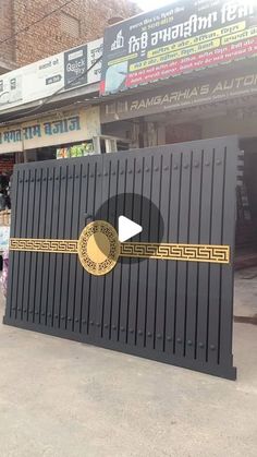 a large black and gold sign on the side of a building