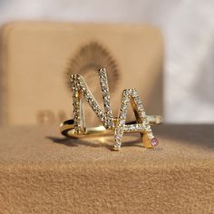 "● Indulge in the timeless elegance of our Custom Round Cut Moissanite N and A Letter Ring in 14K Yellow Gold. This exquisite ring is meticulously crafted to perfection, featuring a stunning round cut moissanite stone set in lustrous 14K yellow gold. Personalize your love story with the initials \"N\" and \"A\" elegantly engraved on either side of the center stone, symbolizing your unique bond. All Designs Are computer-generated designs. Original Product Might look a little different than this. This solid handmade ring is the perfect gift for the significant other or special best friend, they can wear it as a wedding ring or to complete their formal or casual wear, The joy of a handmade ring is its unique design, and it makes an interesting conversation piece. ● We Offer Custom Free Engrav Luxury Initial Ring With Brilliant Cut, Luxury Elegant Diamond Ring With Initials, A And N Letters Love, Diamond Promise Ring With Initials, Anniversary Cubic Zirconia Rings With Initials, Anniversary Initial Ring With Vs Clarity Round Cut, Vs Clarity Round Cut Initial Ring For Anniversary, Wedding Diamond Ring With Initials, Fine Jewelry Diamond Ring With Initials For Anniversary