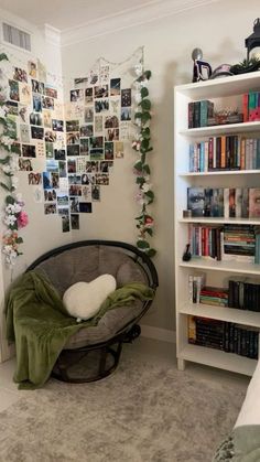 a bedroom with a bed, book shelf and bookshelf filled with pictures on the wall