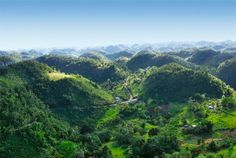 an aerial view of lush green hills and valleys