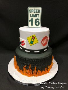 a cake that is decorated to look like a speed limit sign on top of a tire