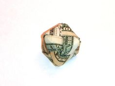 a money origami ball made out of one hundred dollar bills on a white background