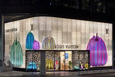 the louis vuitton store is lit up at night with colorful lights on it