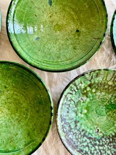 We absolutely love these Tamegroute emerald bowls for their primitive feel and dazzling color. The ancient city of Tamegroute - translated to " the last place before the desert" - in Morocco is home to the ceramic workshops of many families who have been making the renowned green glazed pottery for centuries. Dating back to the 1600's artisans have gathered clay from nearby palm groves, digging many meters beneath the surface to collect their materials. Pieces are hand- built or made on a potter Ceramic Workshop, Kitchen Bowls, Glazed Pottery, Green Bowl, Bow Shop, Ancient City, Beneath The Surface, Artist Gifts, Glazes For Pottery